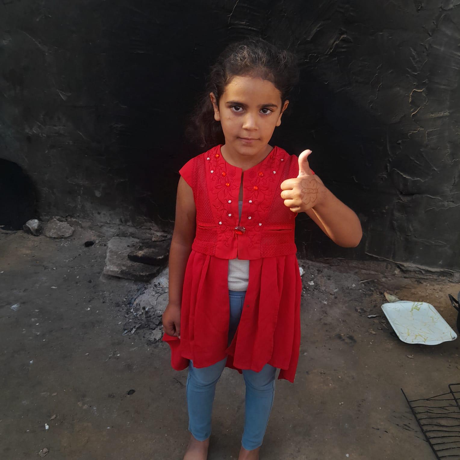 Girl smiling and giving a thumbs up