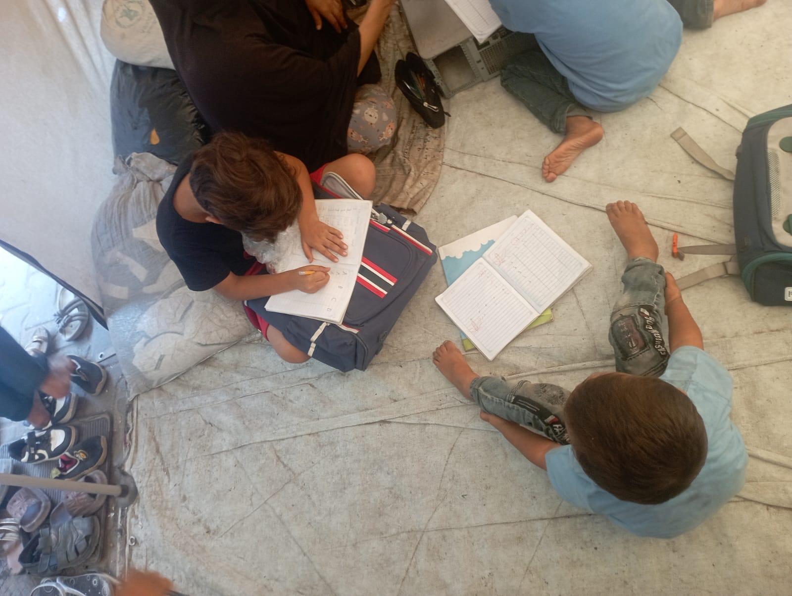 Boy writing in his notebook